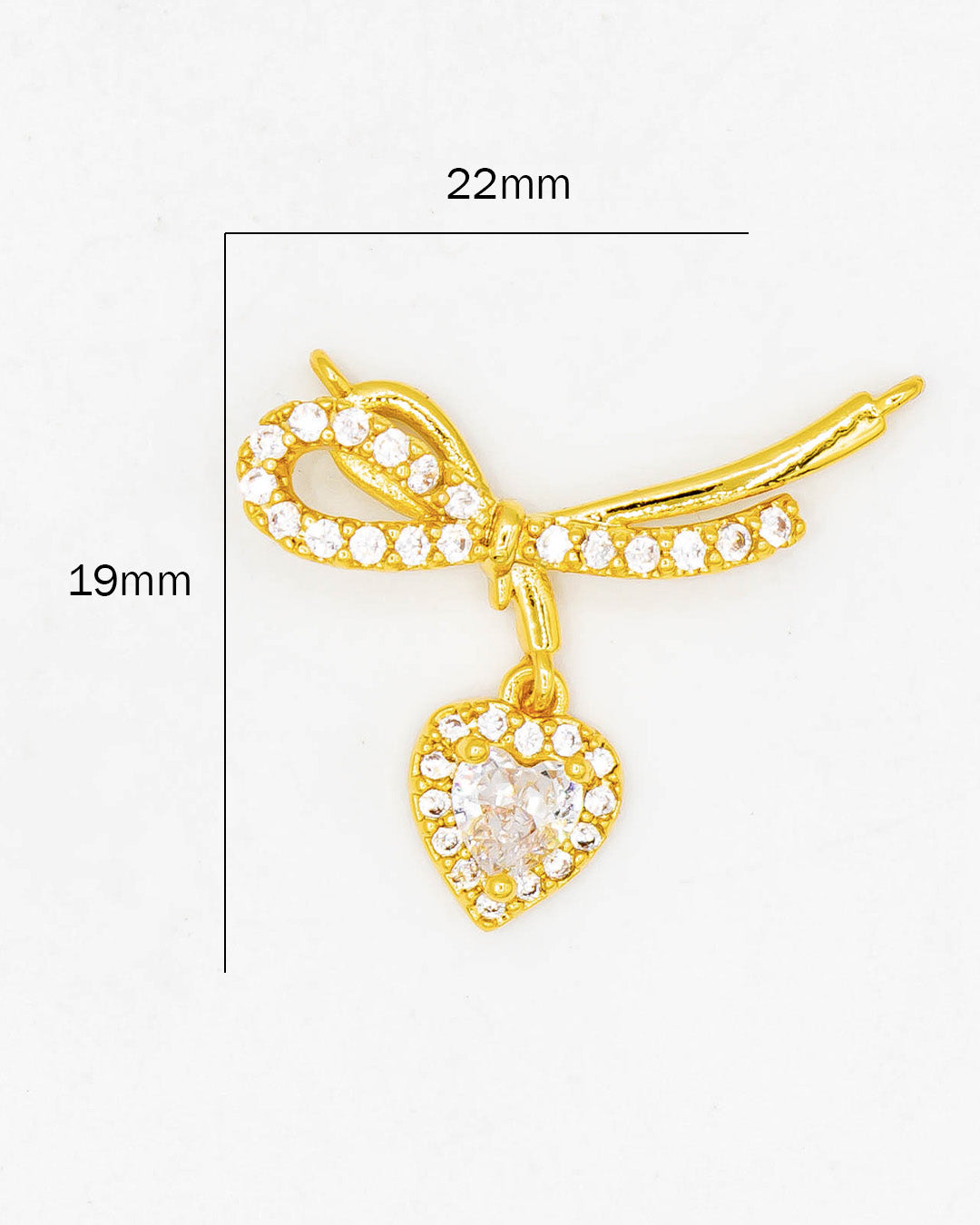 Dije moño con corazón