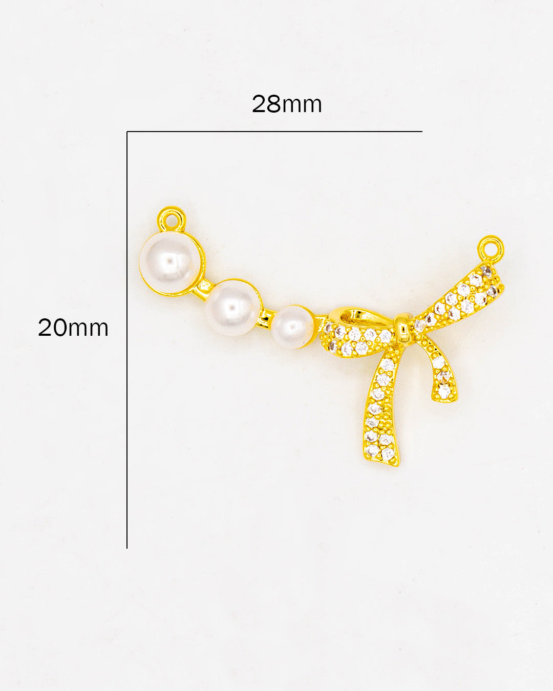 Dije moño con perlas