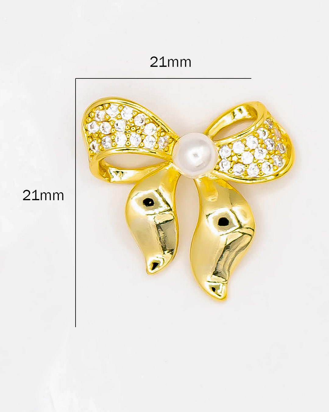 Dije moño con perla