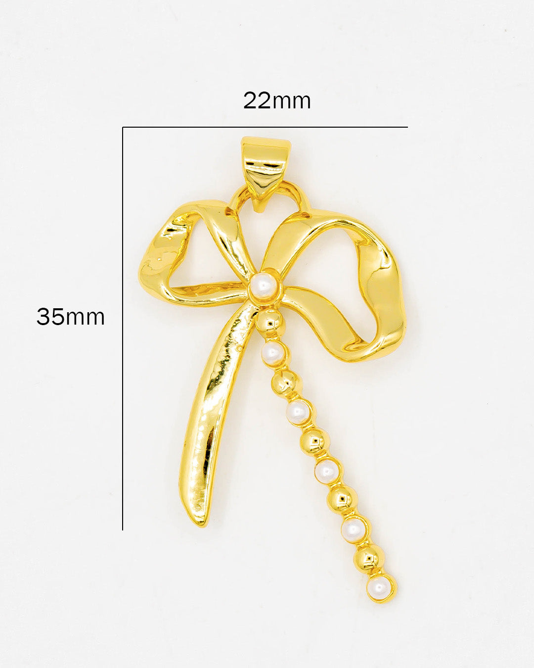 Dije moño con perlas